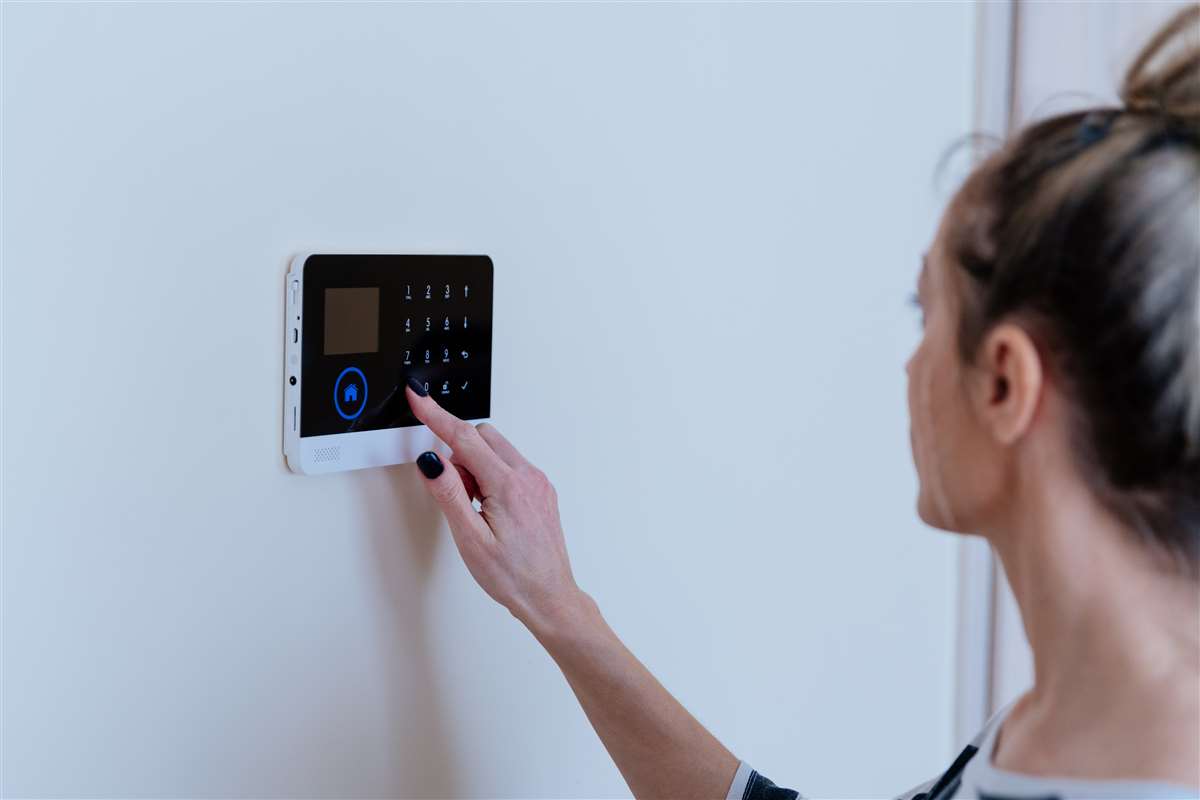 una donna aziona il sistema d'allarme di casa