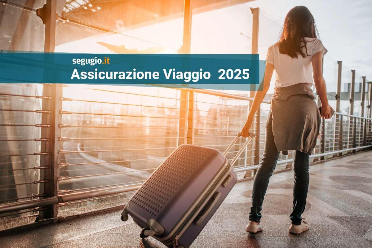 offerte assicurazioni viaggio 2025 donna trascina una valigia su un ponte