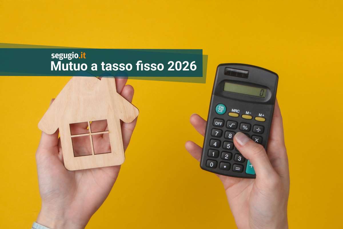 due mani reggono una calcolatrice e un modellino di casa