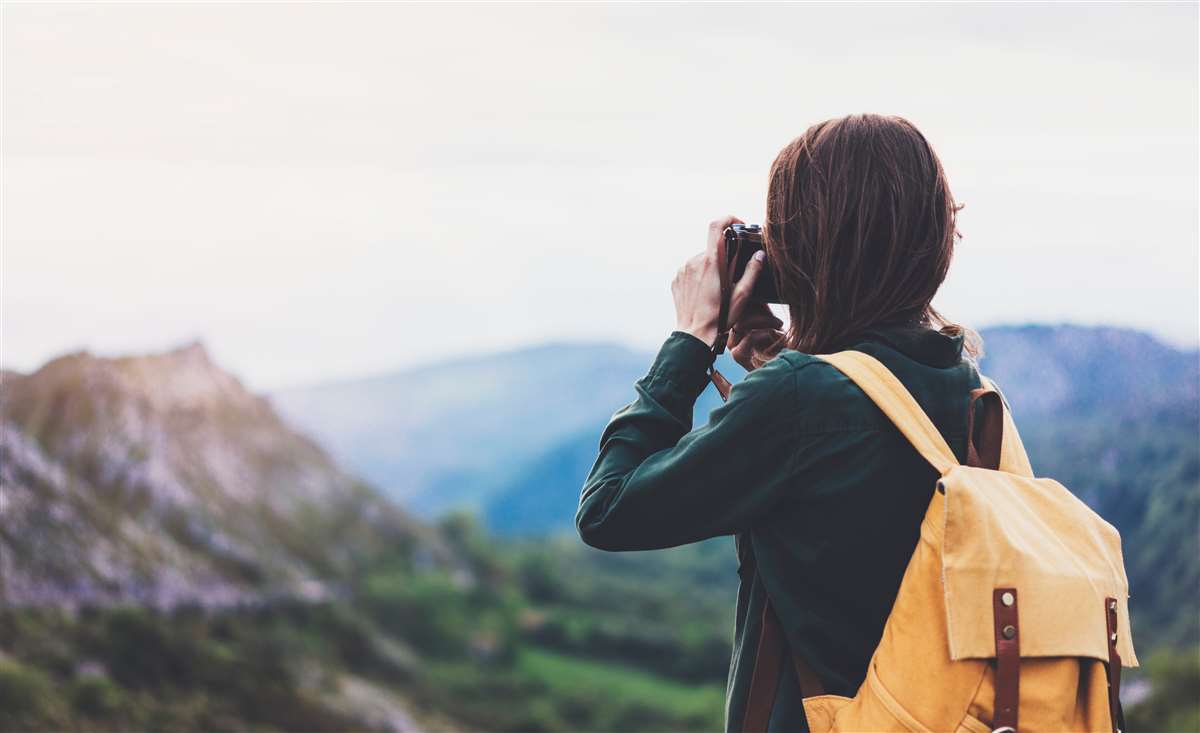 turista scatta fotografia a paesaggi montani